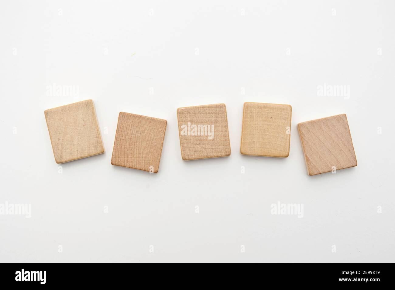 five blank wooden tiles isolated Stock Photo