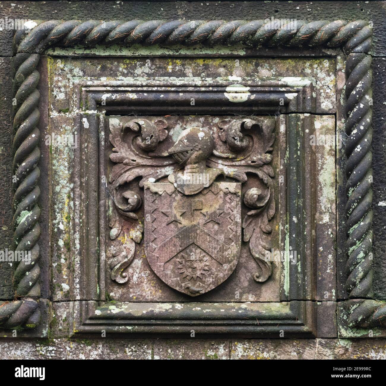 Ewing family coat of arms carved in red sandstone on the centre of Ballikinrain castle entrance arch, Fintry Road, Balfron, Stirling, Scotland, UK Stock Photo