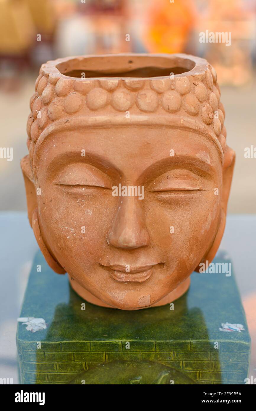 Beautiful handmade statuette of a Buddha head is displayed in a shop
