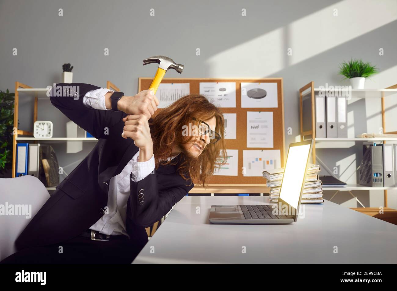 Angry office worker annoyed with computer error or pop up ads smashing ...
