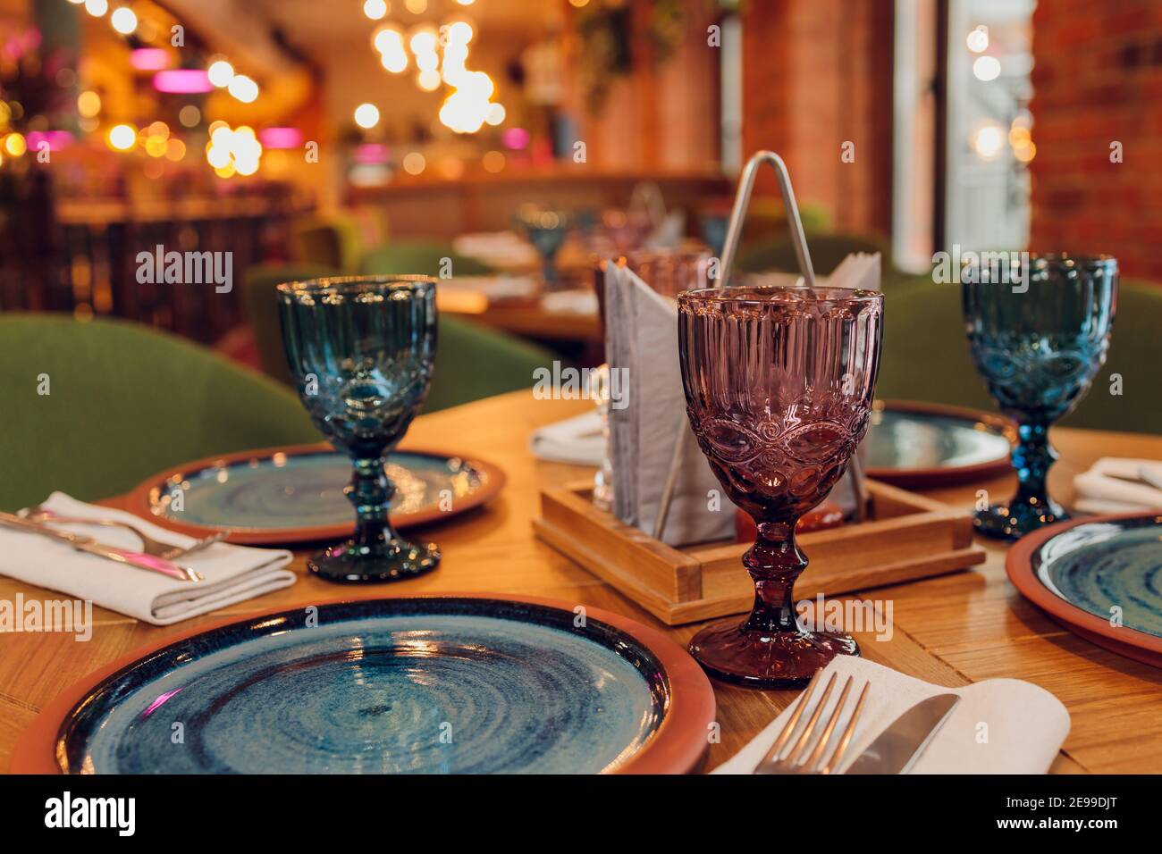 Two Beautiful Glasses Of Glass Stand On The Table With A Plate In The Red Interior Stock Photo Alamy