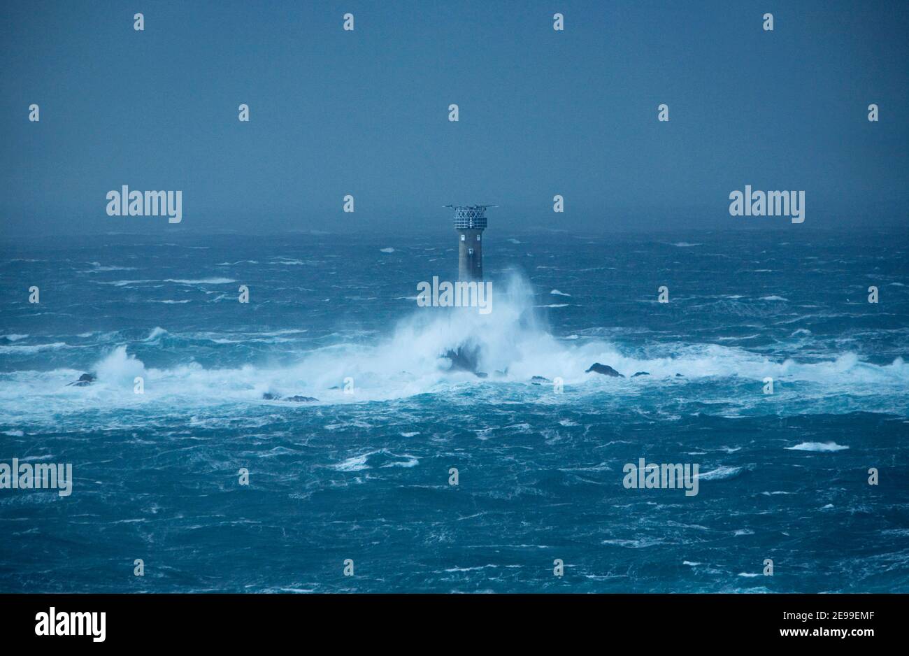 Waves Crashing against Longships Lighthouse in Stormy Seas. Cornwall. England. UK. Stock Photo