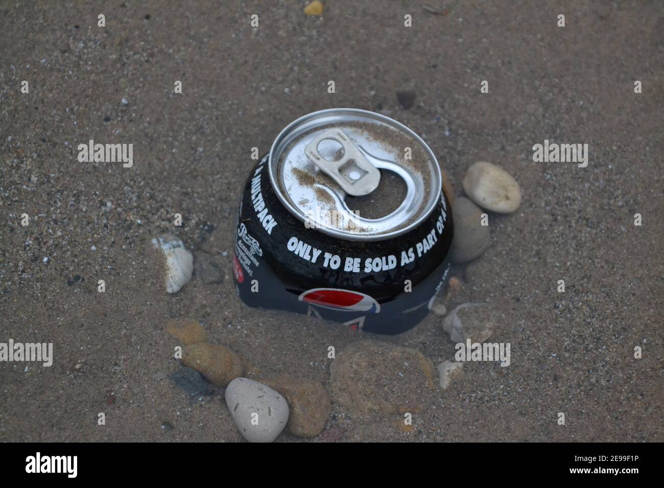 Soft Drinks Can Left On A Beach - Pushed Into The Sand - Rubbish - Litter in Sand - Pebbles / Stones / Sand - Waste Pollution - Yorkshire - UK Stock Photo