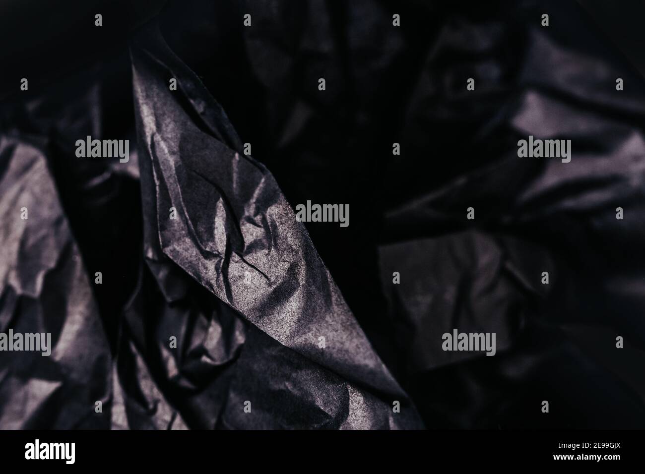 Crumpled black paper texture abstract background Stock Photo - Alamy