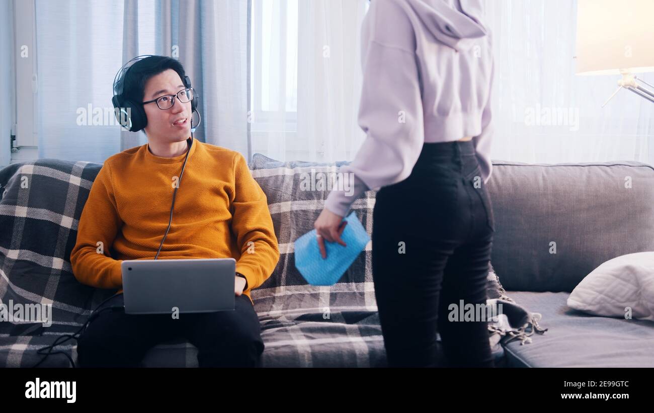 Young man playing games on his laptop and ignoring his girlfriend ...