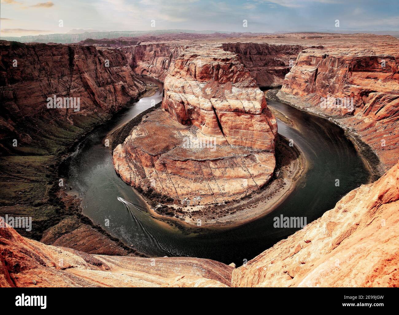 A speed boat motors down the Colorado River at Horse Shoe Bend near Page, Arizona. Stock Photo