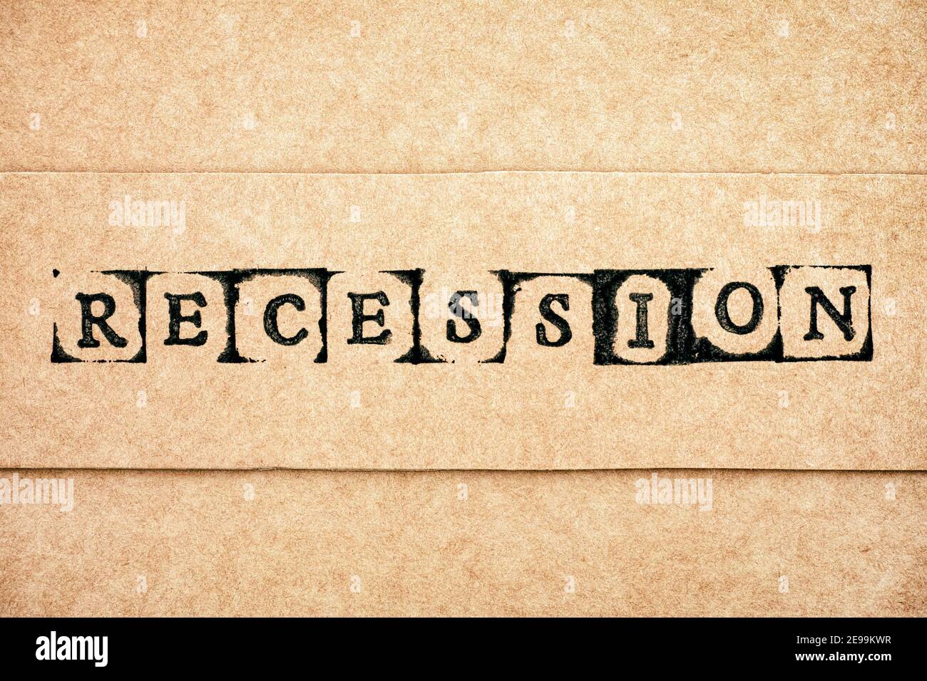 Cardboard with word Recession made by black alphabet stamps. Stock Photo