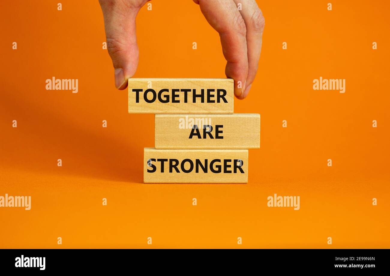 Together Are Stronger Symbol Concept Words Together Are Stronger On Wooden Blocks On A Beautiful Orange Background Businessman Hand Business Mot 2E99N6N 