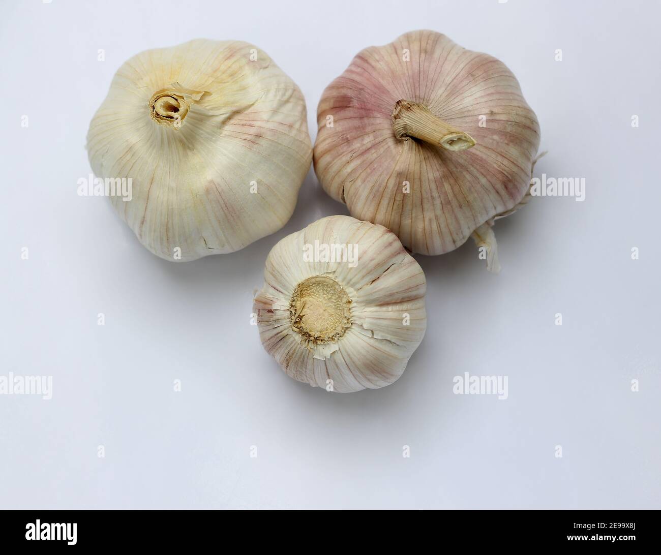 Three garlic turn up and down on white background Stock Photo