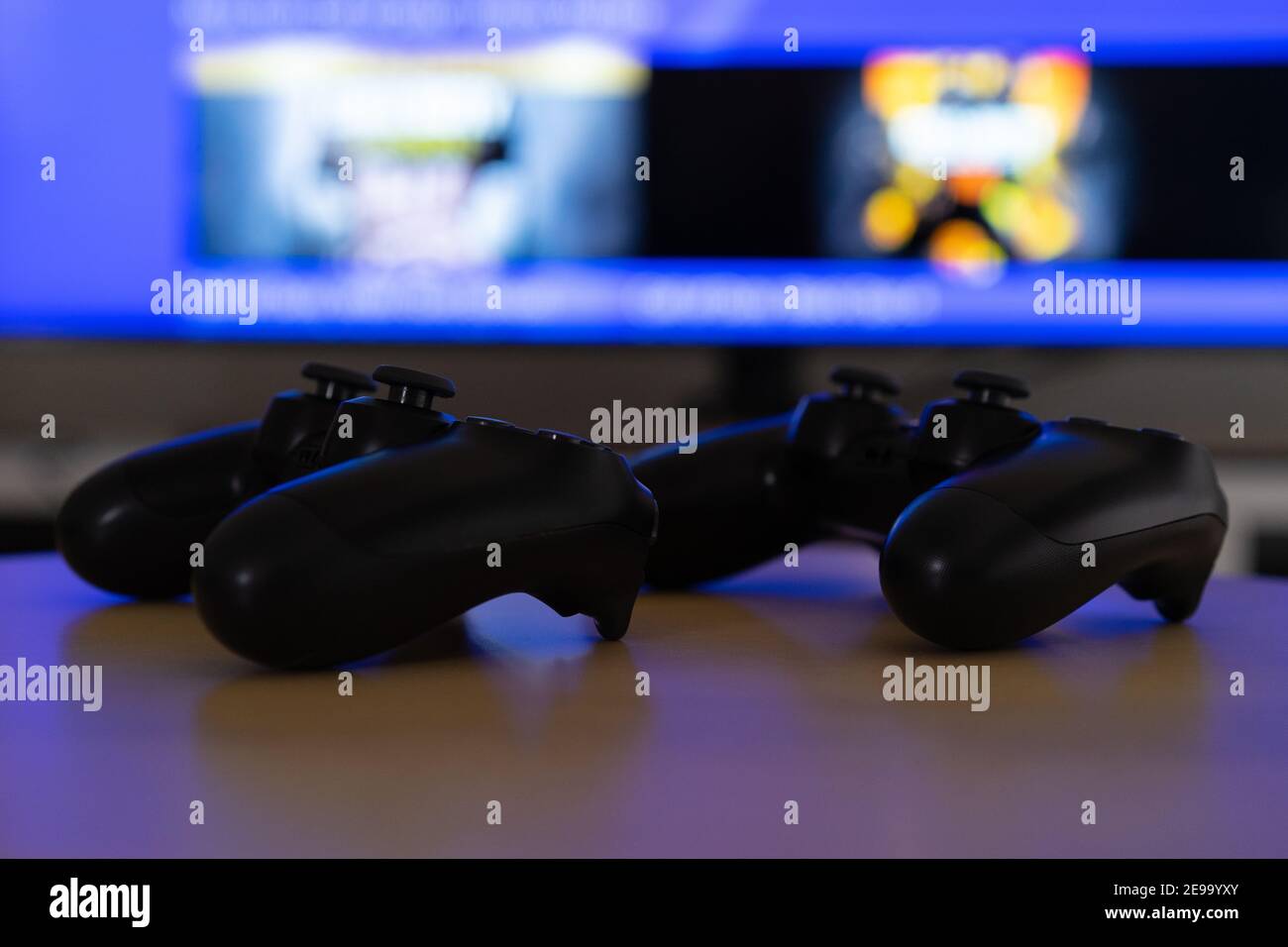 Gaming controller in hands, playing games and online streaming with gamer  competition and esports. Video game tech, streamer person in dark room and  play tournament with joystick and keyboard Stock Photo