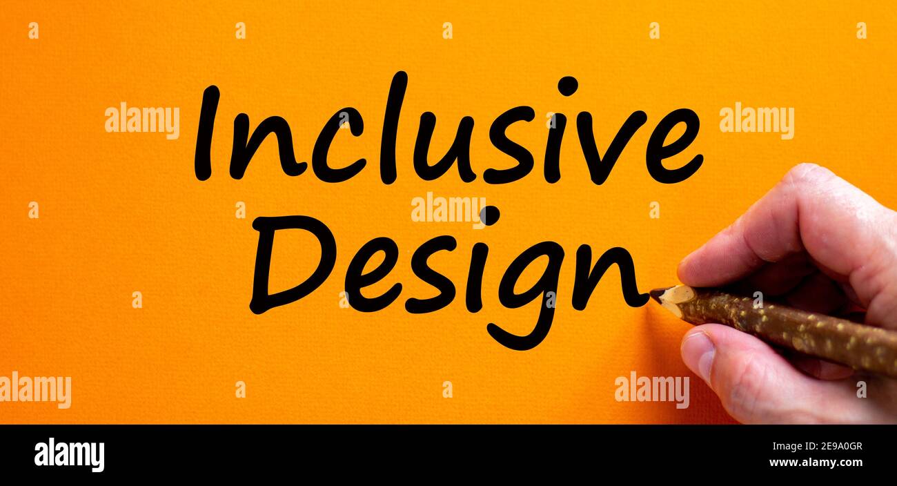 Inclusive design symbol. Hand writing 'inclusive design', isolated on orange background. Business, inclusion and inclusive design concept. Copy space. Stock Photo
