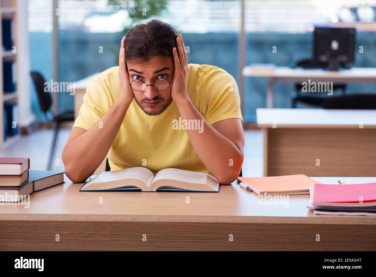 Young student preparing for exams in the classroom Stock Photo - Alamy