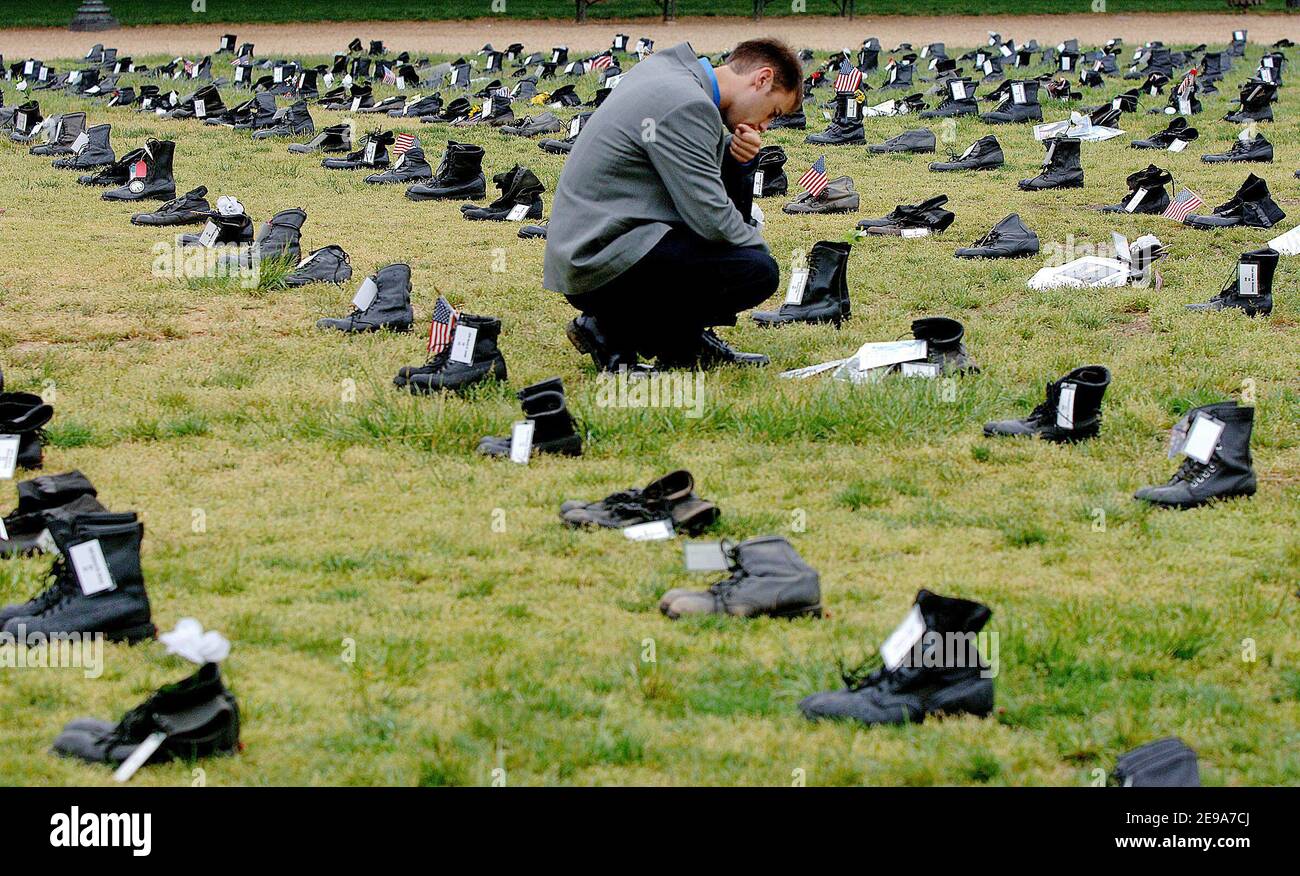 Cody Sheehy, from Oregon, takes a reflective moment in front of the boots and a picture of his friend Fred Pokerney, a marine who died in Iraq. The 'Human Costs of War' exhibit, a pair of combat boots for every U.S. military casualty in Iraq is in display at the National Mall in Washington DC, USA on May 11, 2006. Photo by Olivier Douliery/ABACAPRESS.COM Stock Photo