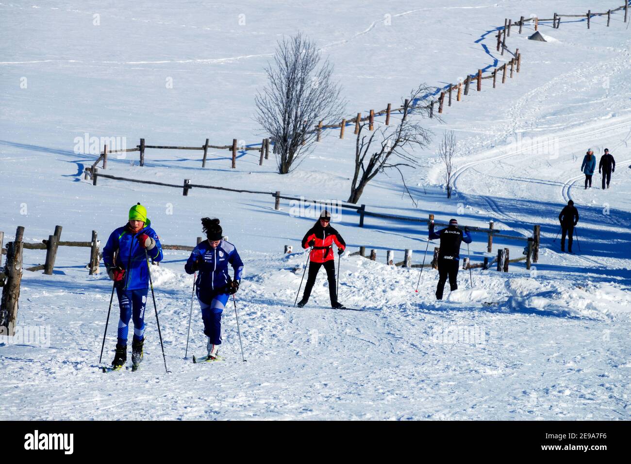 Active people Skiers skiing Winter Sports Countryside Snow ridge trail in Ore Mountains Czech Republic Stock Photo