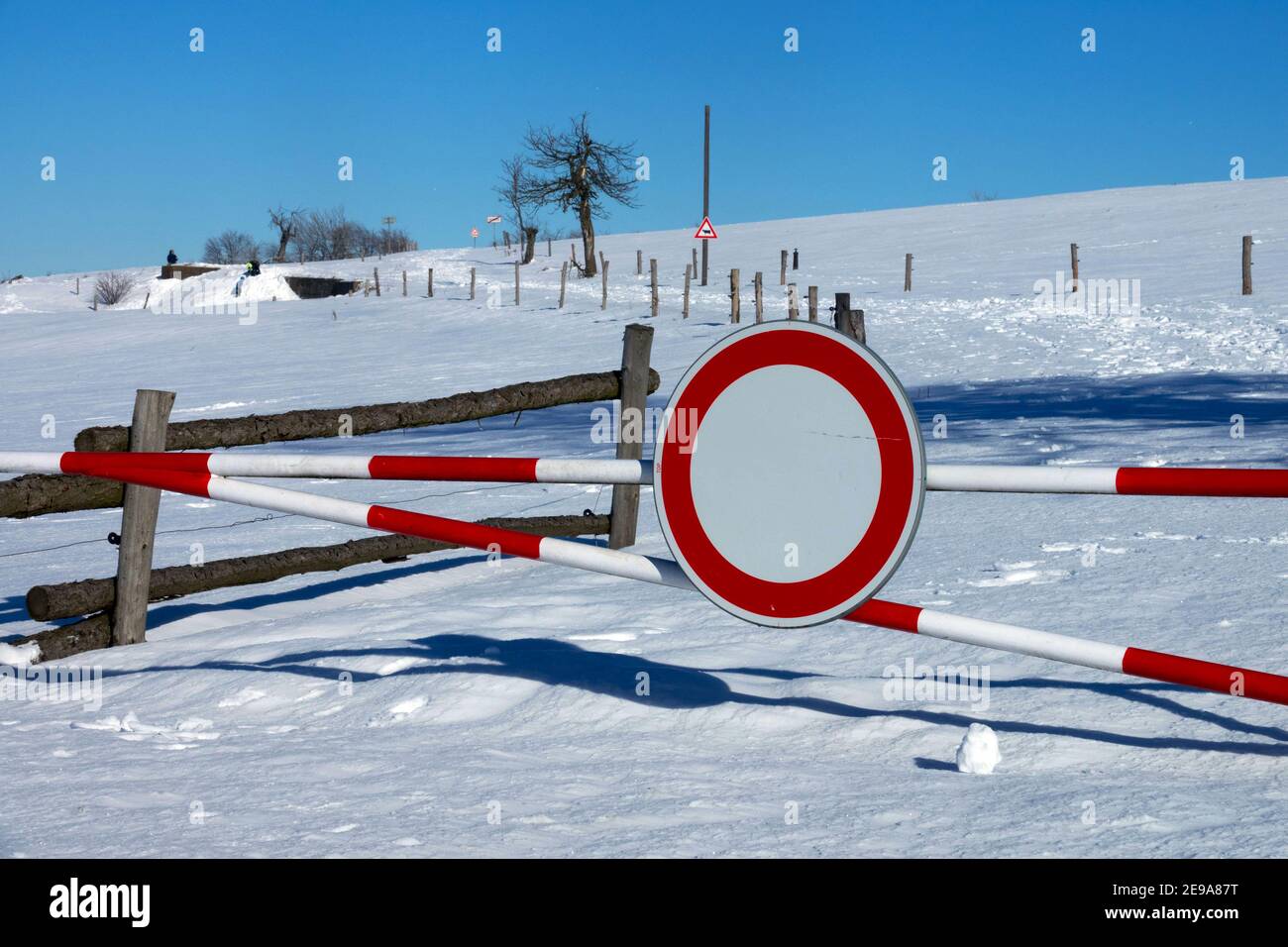 Traffic sign - no entry on a road that is not maintained in winter, snow covered rural Czech Republic road snowdrift scenery Stock Photo