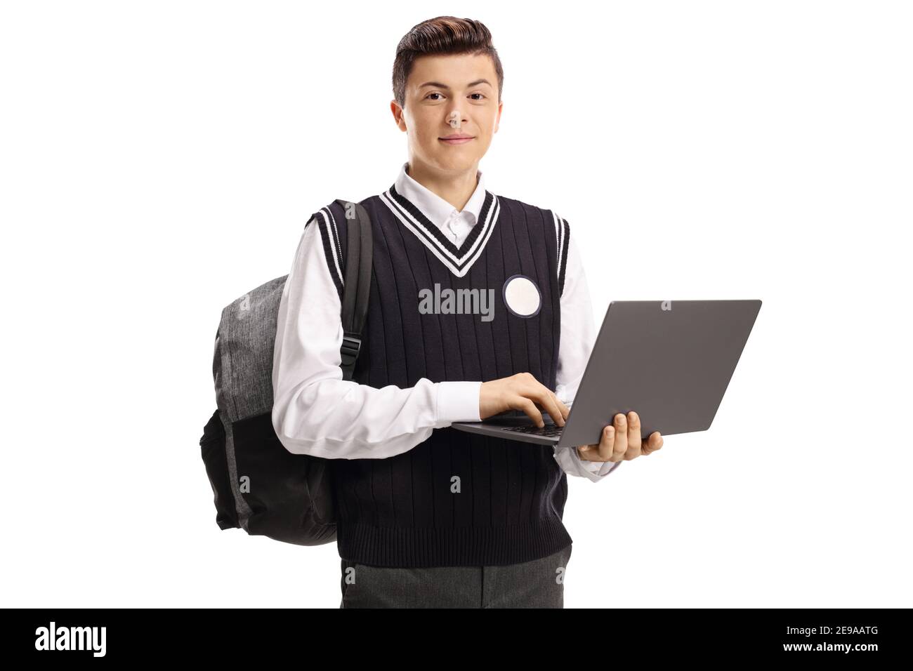 Teenage student in a school uniform holding a laptop computer isolated ...