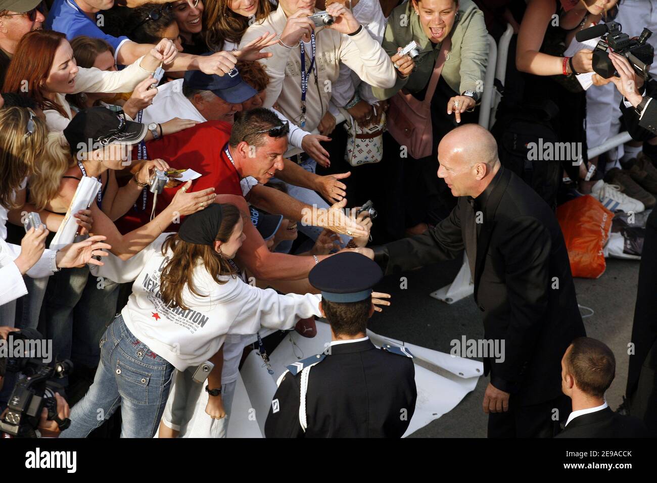 Bruce Willis greets fans on the red carpet prior the screening of the movie 'Over the Hedge' presented out of competition during the 59th Film Festival in Cannes, France on May 21, 2006. Photo pool by Benainous/ABACAPRESS.COM Stock Photo