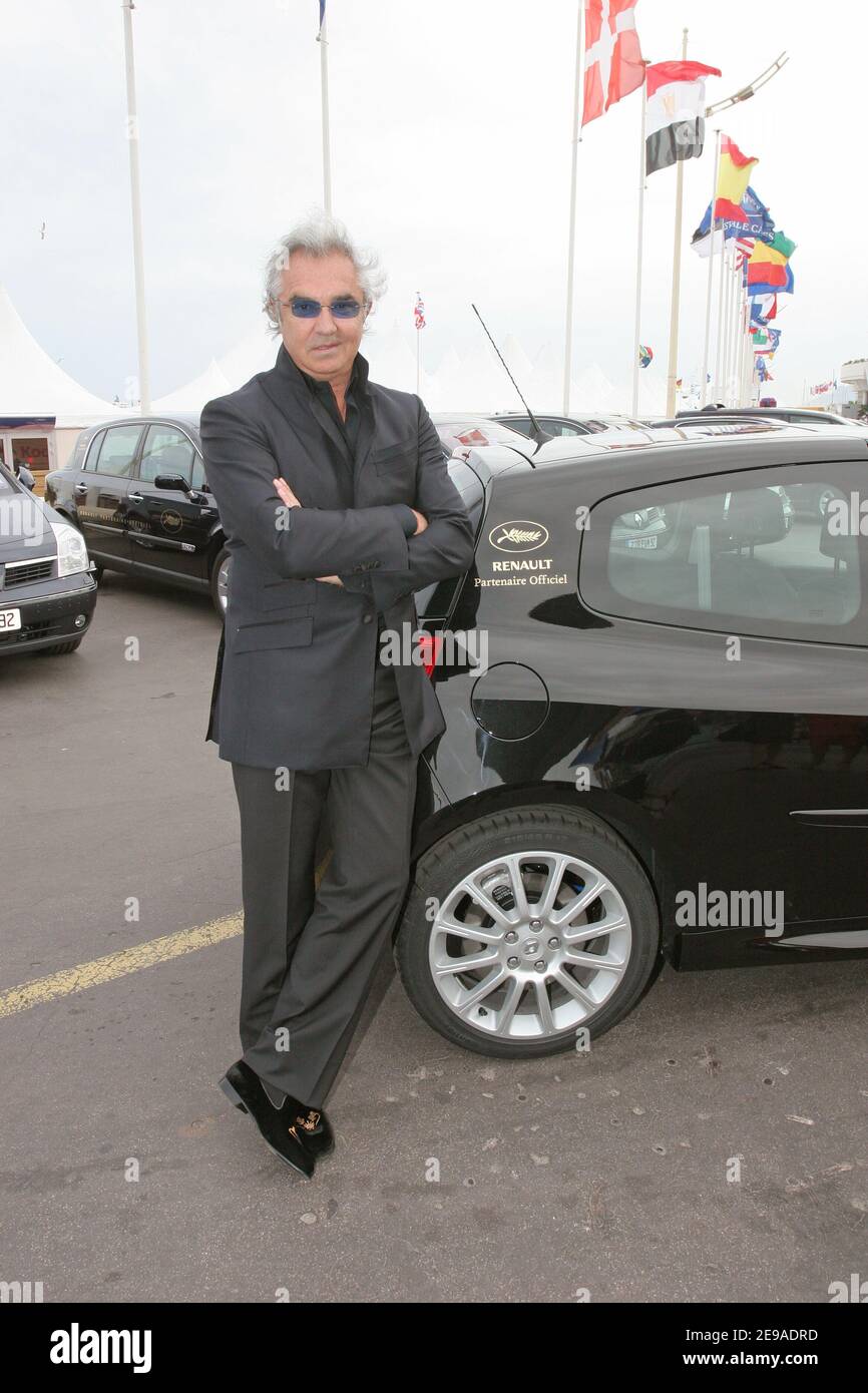 EXCLUSIVE. Renault Formula One team manager, Italian Flavio Briatore, poses  in front of the new Renault Clio Sport car outside the Palais des Festivals  in Cannes, France, on may 23, 2006. Few