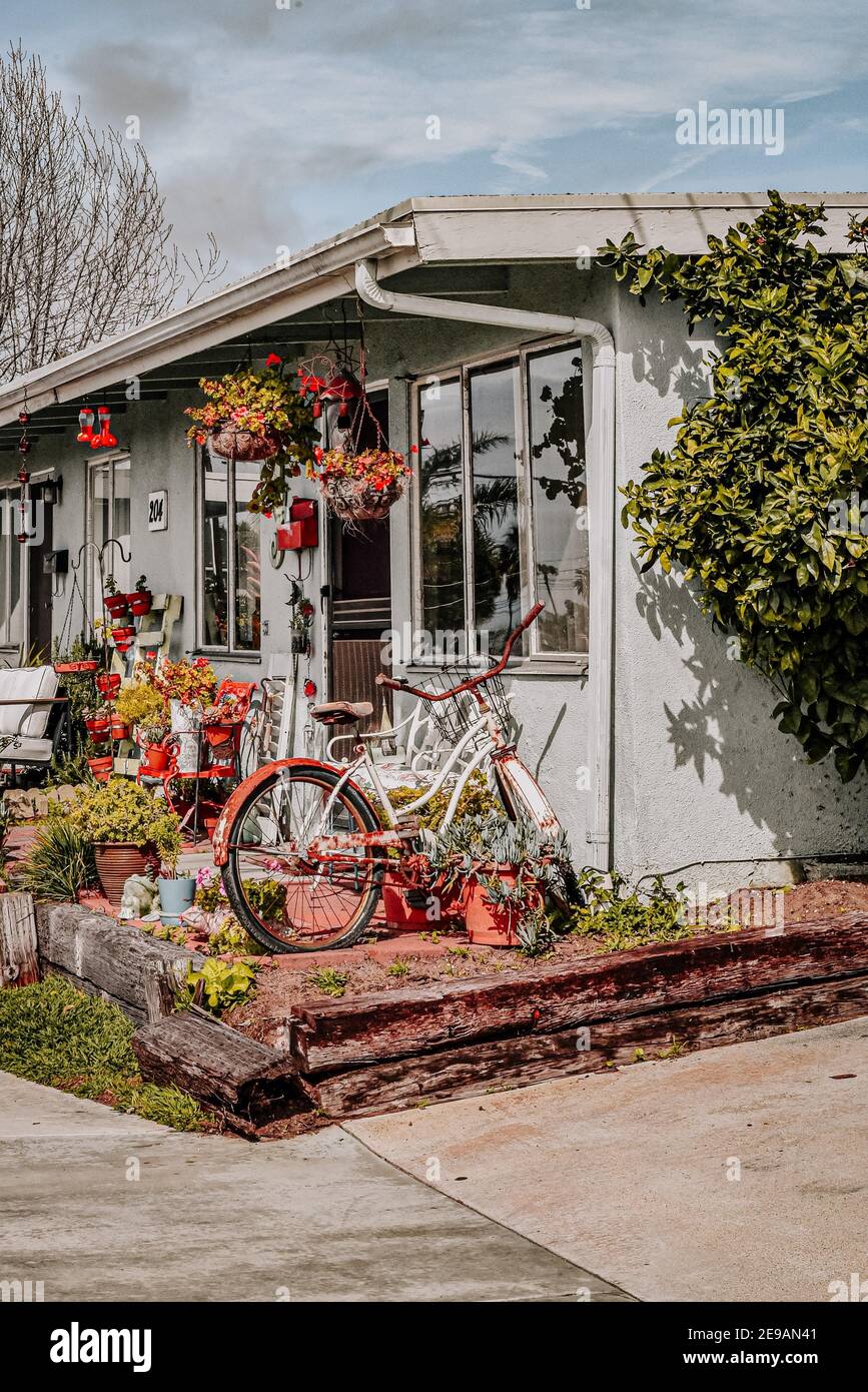 exterior-of-a-house-with-flowers-and-a-bicycle-standing-in-front-of-it