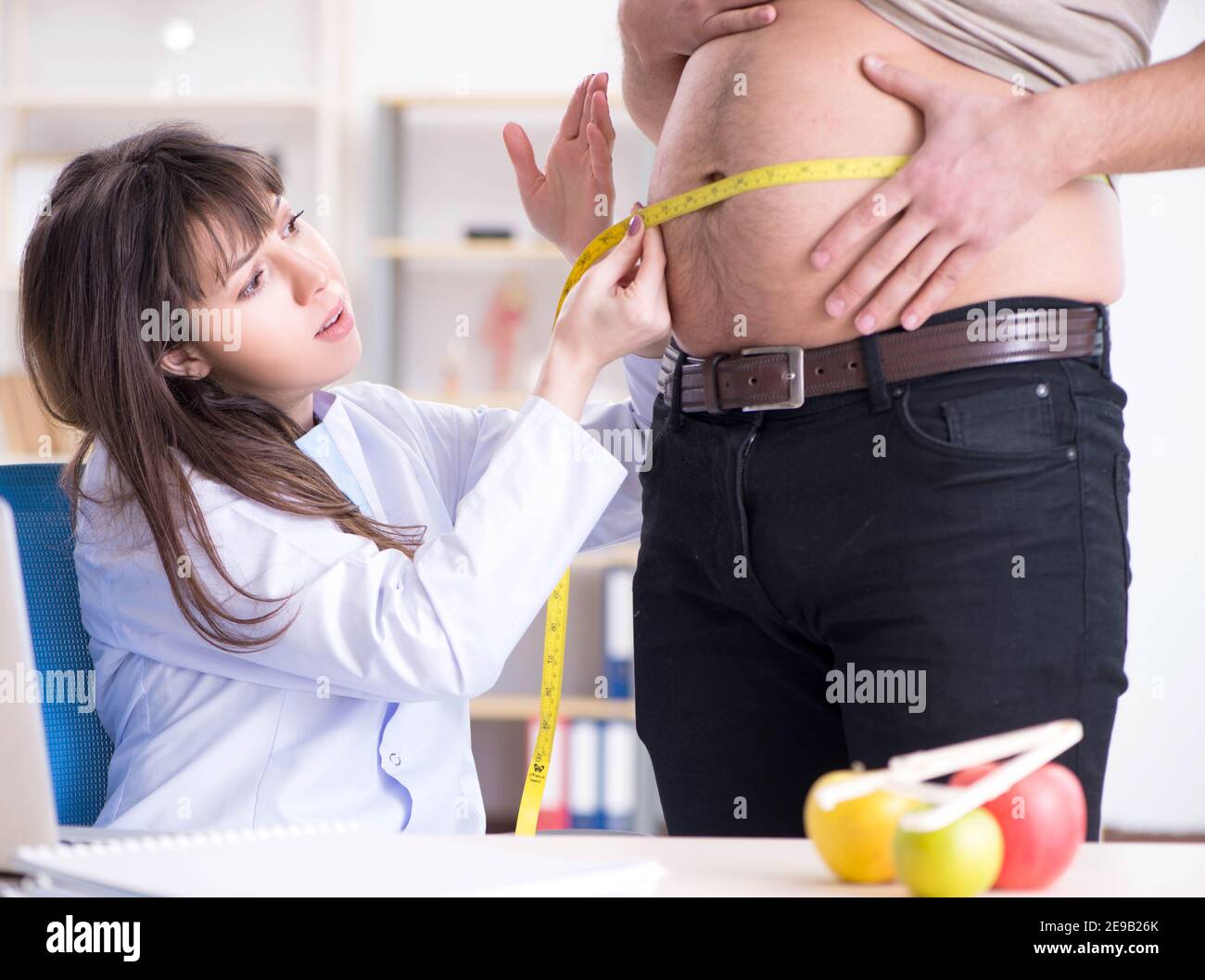 The doctor dietician giving advices to fat overweight patient Stock