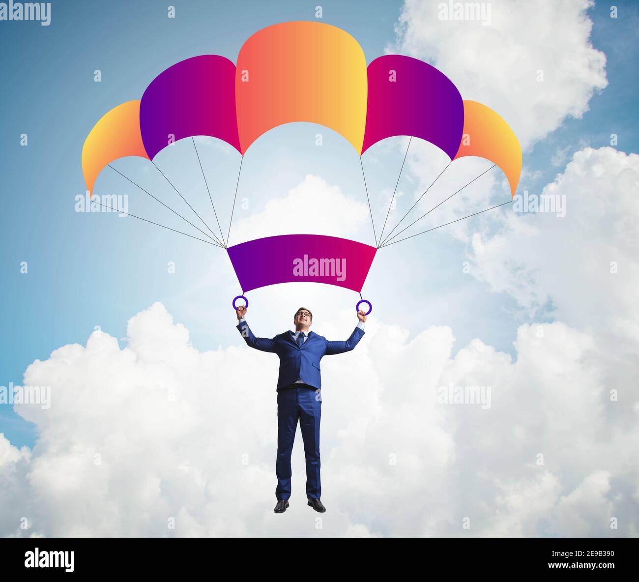 The young businessman falling on parachute in business concept Stock