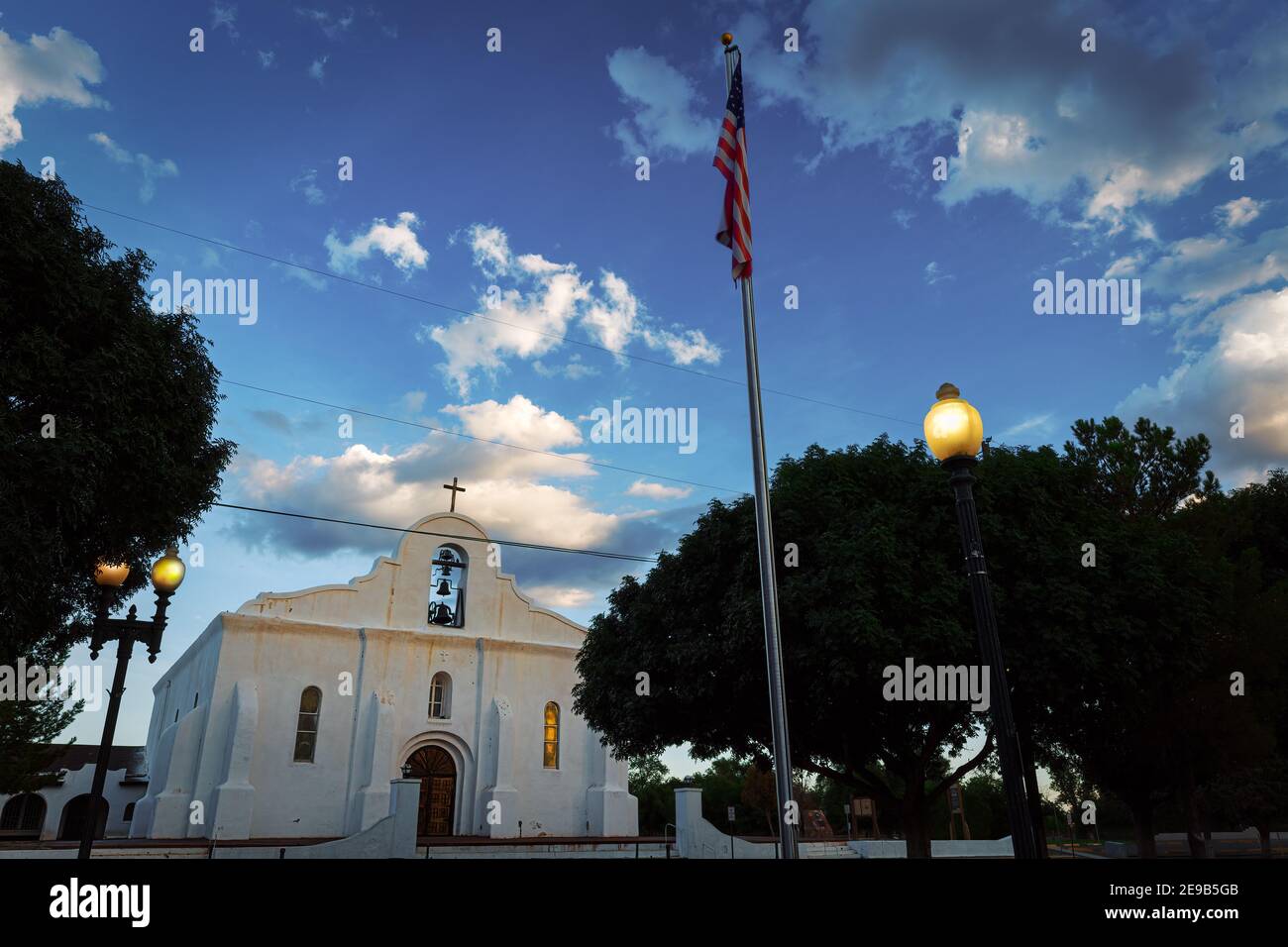An American flag flies one e; vening at the San Elizario Mission in San