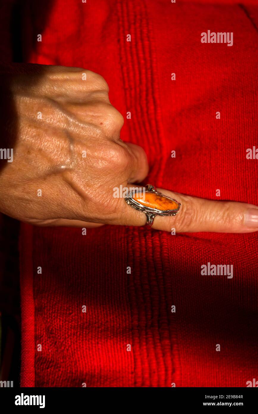 Female hand with an orange ring on an orange cover Stock Photo