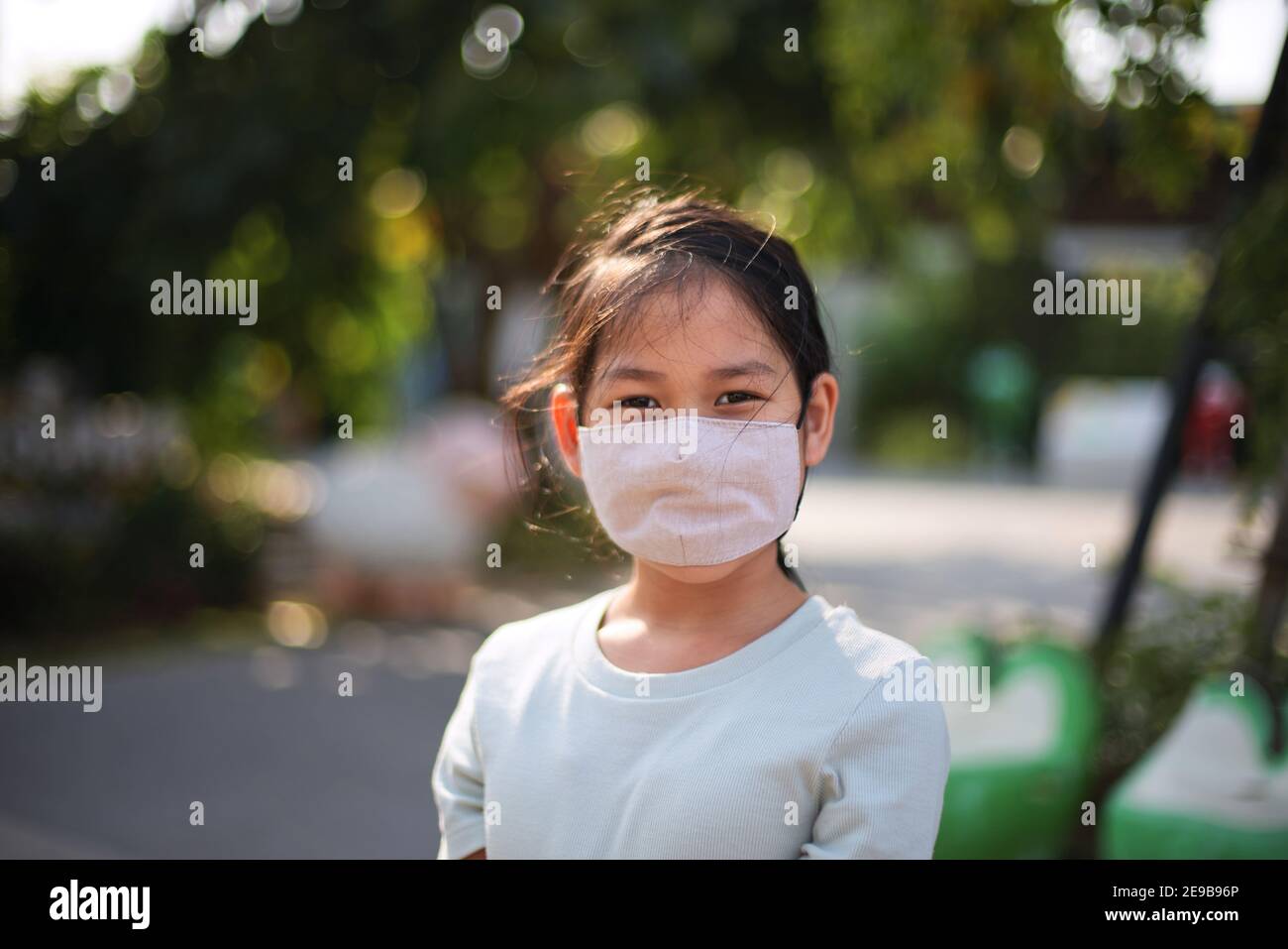 A girls wearing the reusable cotton masks to protect from COVID-19 Stock Photo