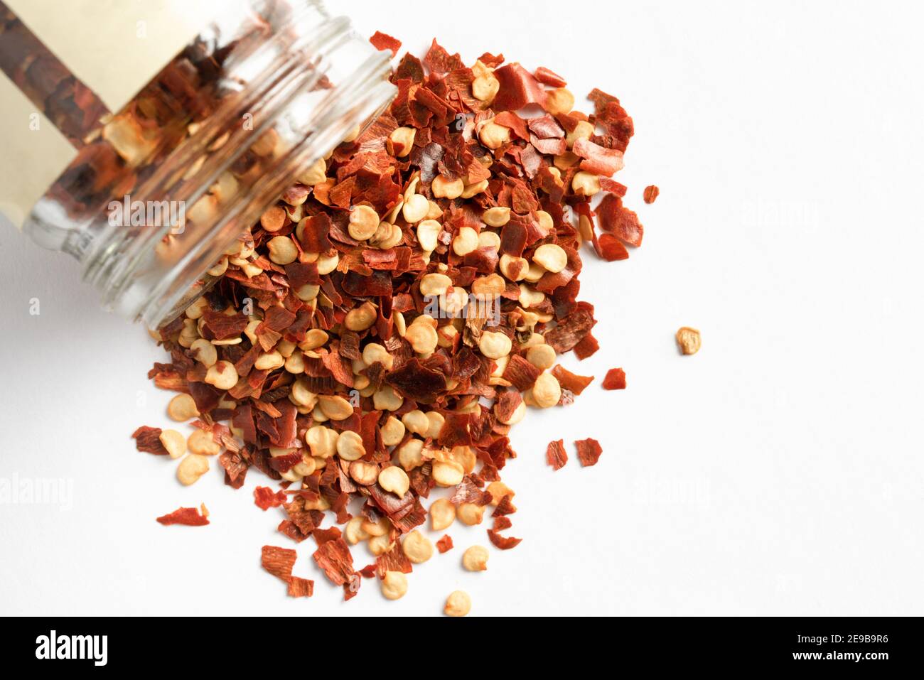 Red Pepper Flakes Spilled from a Spice Jar Stock Photo Alamy