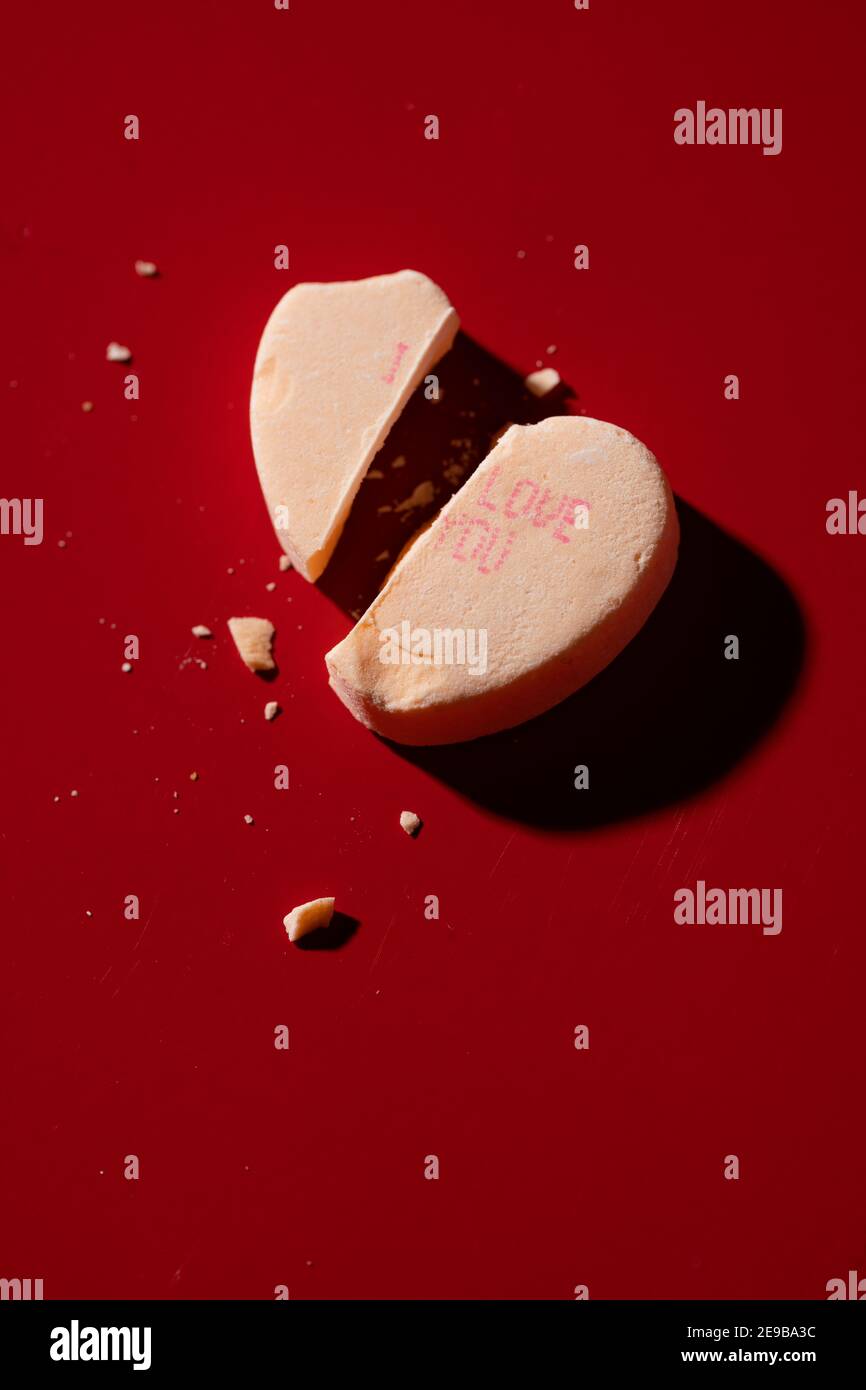 A broken candy conversation heart with 'I Love You' printed on it Stock Photo