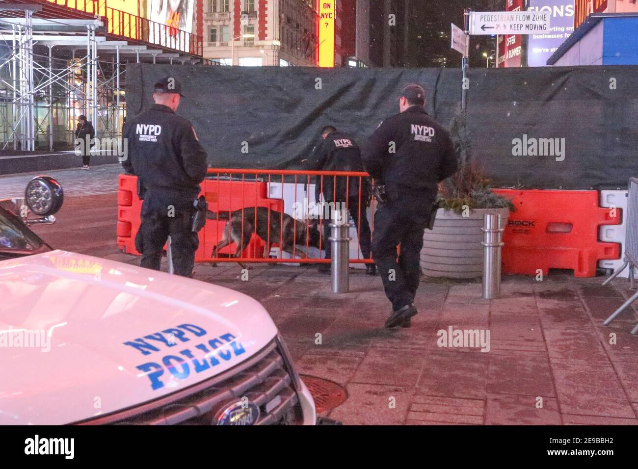 New York City USA NYPD police officers use a dog to search Times Square for explosive devices. Stock Photo