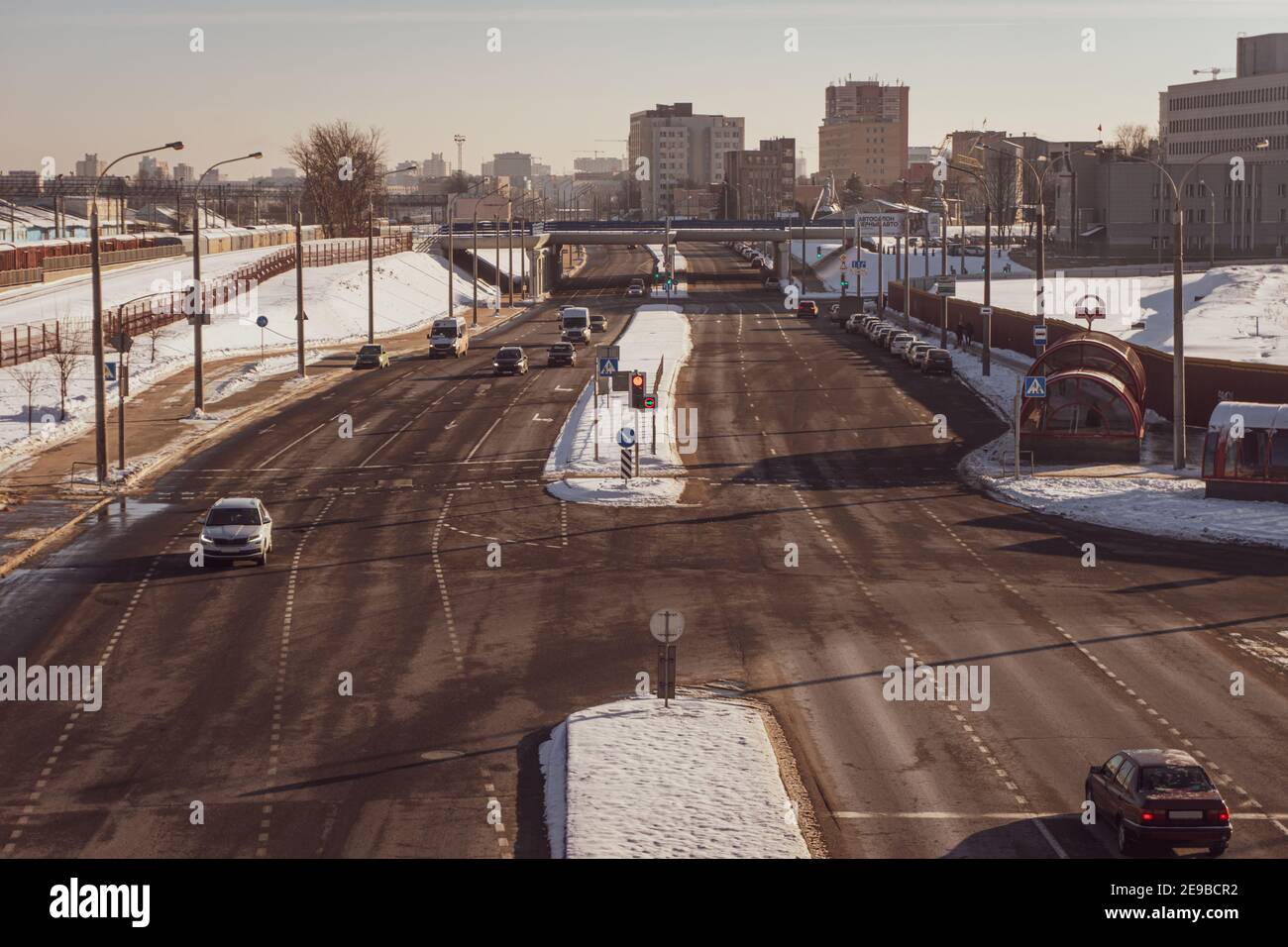 Minsk, Belarus - February 01, 2021: Cars stopped on cross road at a red traffic light and are waiting for a green arrow to turn Stock Photo