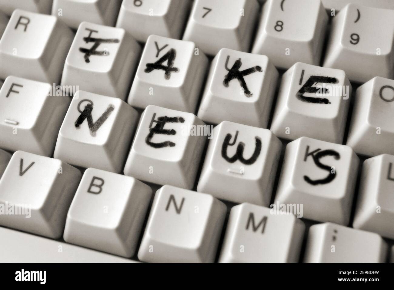 Detail of a computer keyboard with Fake news written on it with marker