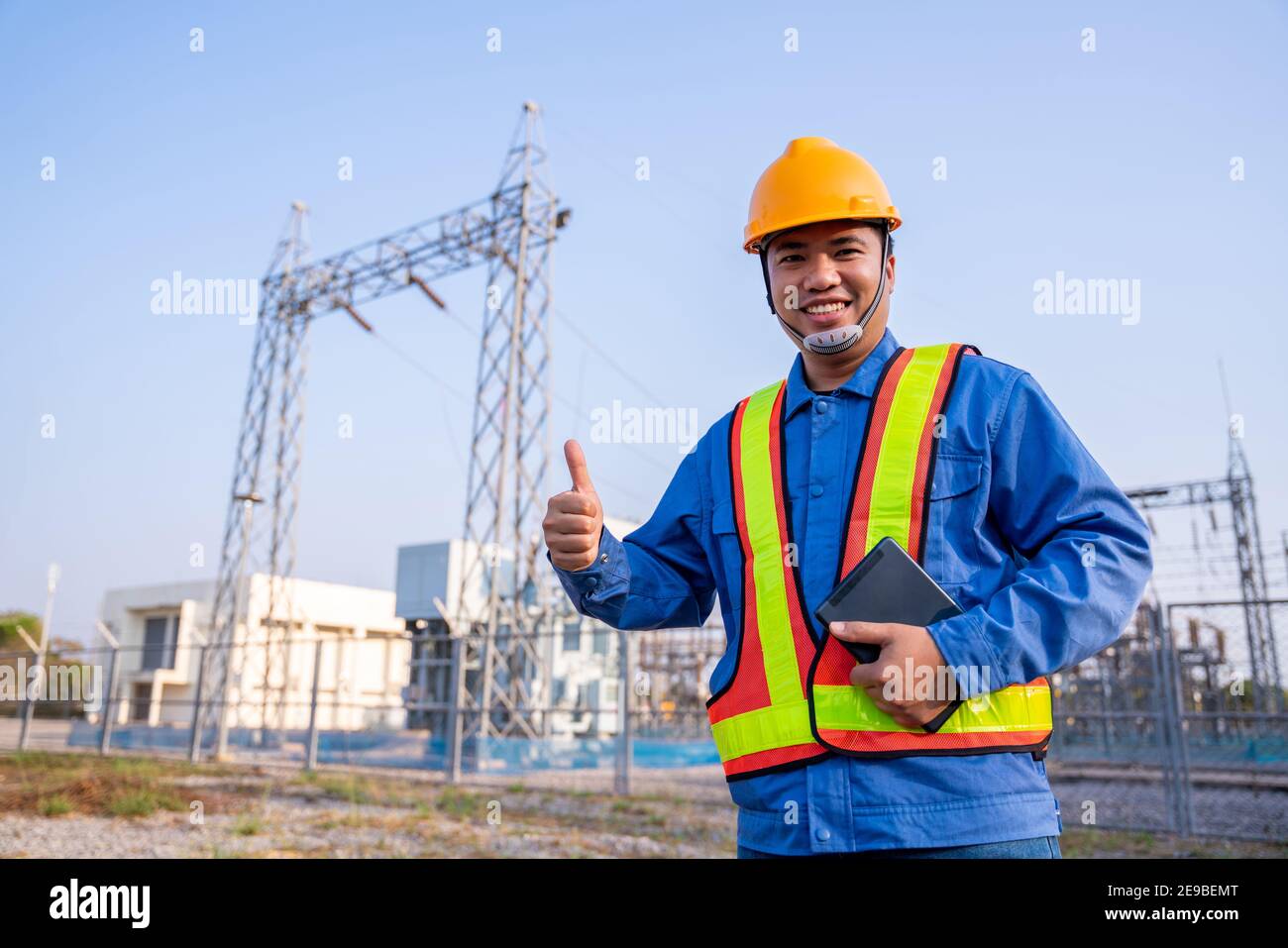 Asain electric engineer reassure wear safety  in transmission station, Concept of electric power safety. Stock Photo