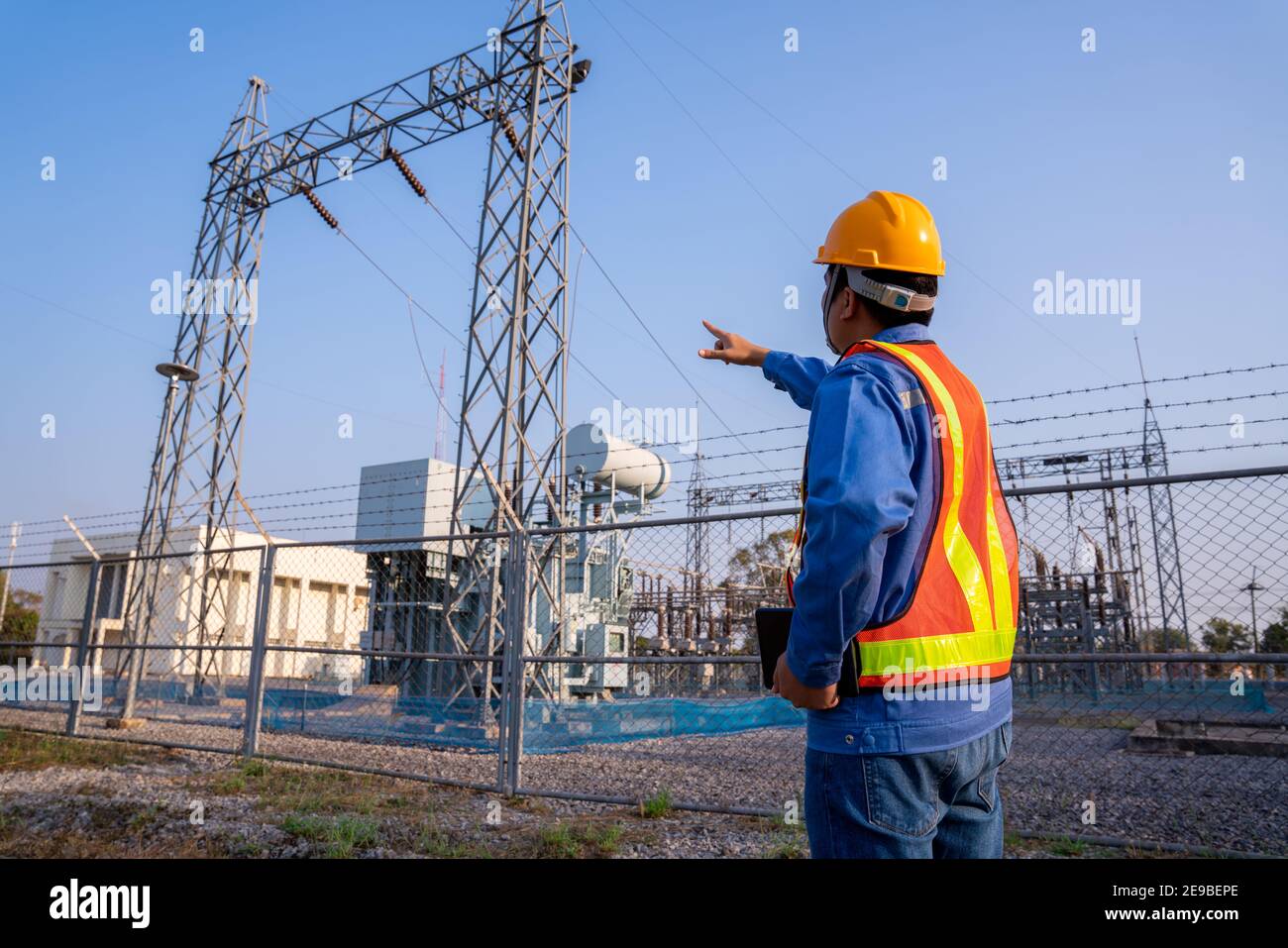 electric engineer wear a helmet check the transmission station, Concept of electric power safety