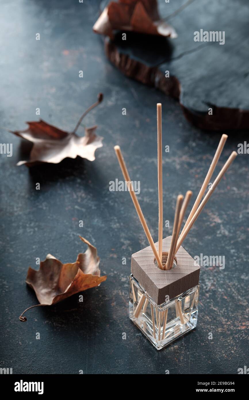 Autumn Scent concept. Bamboo Sticks diffuser. Fragrant air freshener liquid in glass vial with