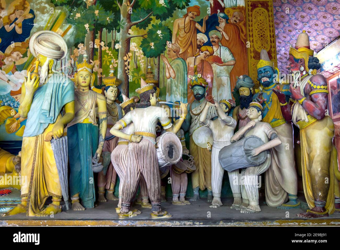 A colourful display of human figures including musicians and drummers in the main Image House at Wewurukannala Vihara at Dickwella. Stock Photo