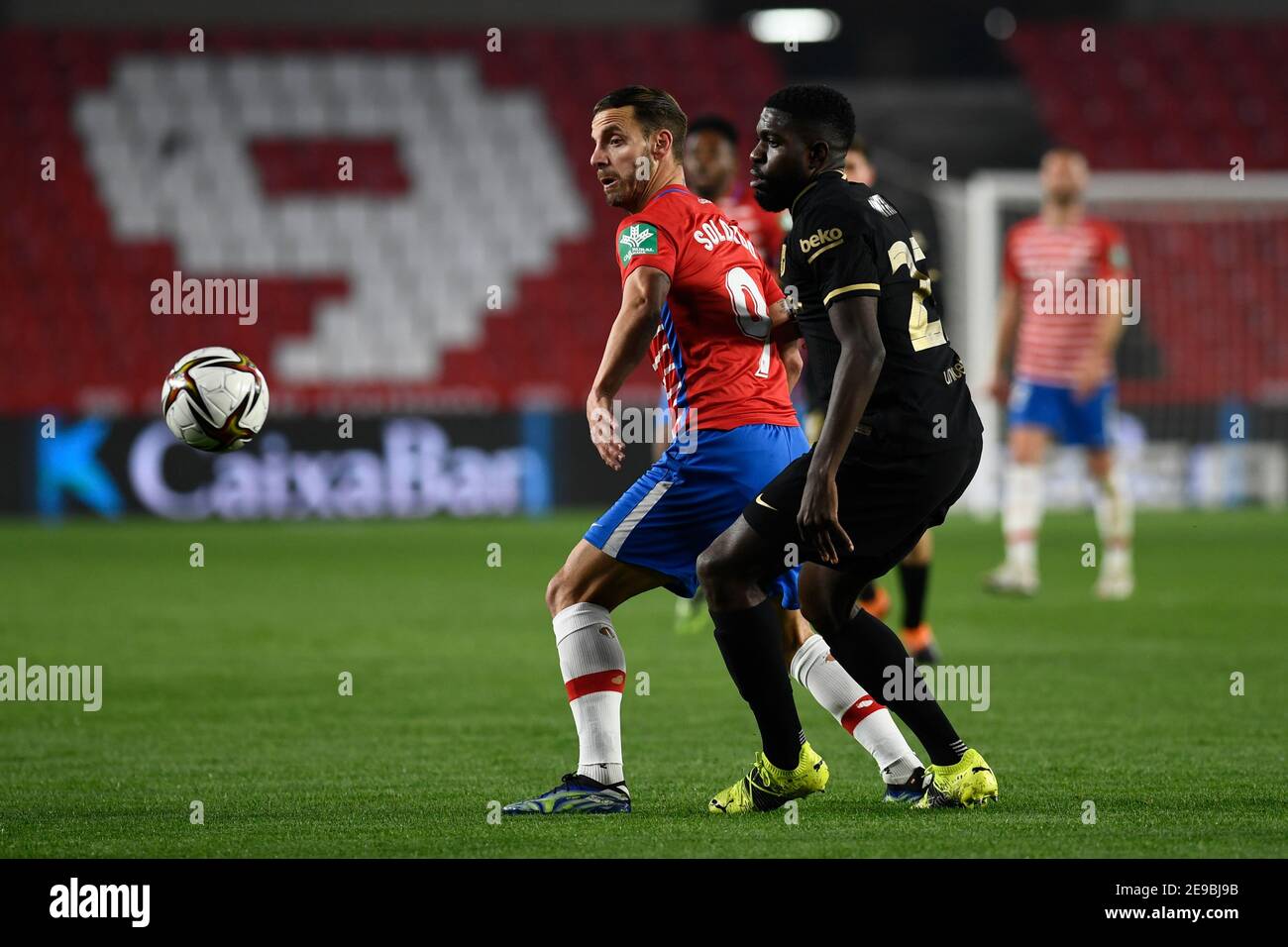 Granada, Spain. 03rd Feb, 2021. Roberto Soldado of Granada CF and Samuel Umtiti of FC Barcelona in action during the Copa del Rey Quarter-final match between Granada CF and FC Barcelona at Nuevo Estadio de Los Cármenes.Final Score: Granada CF 3:5 FC Barcelona. Credit: SOPA Images Limited/Alamy Live News Stock Photo