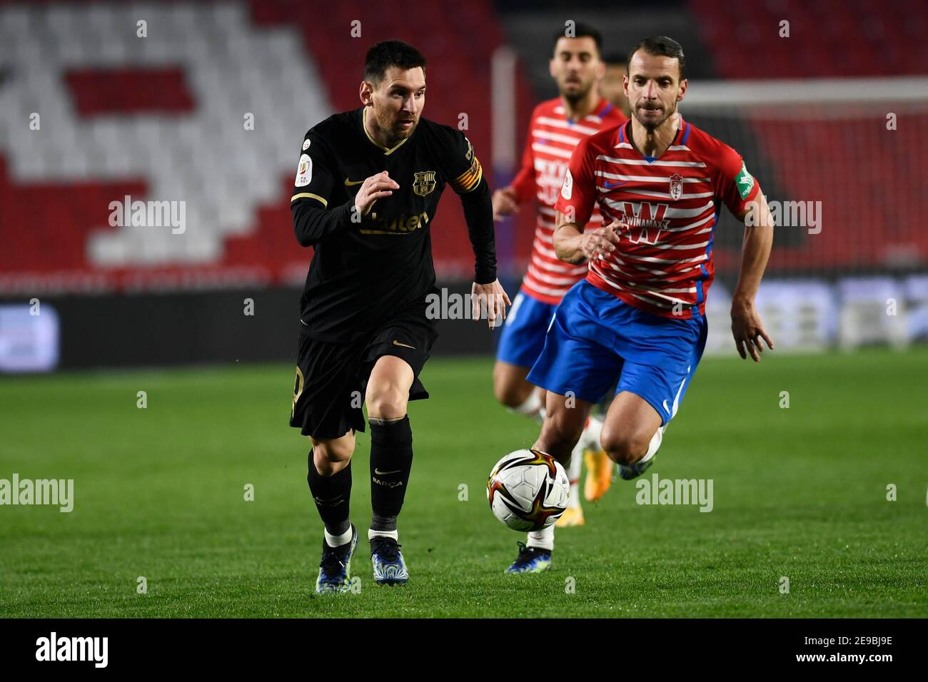 Granada, Spain. 03rd Feb, 2021. Lionel Messi of FC Barcelona and Roberto Soldado of Granada CF in action during the Copa del Rey Quarter-final match between Granada CF and FC Barcelona at Nuevo Estadio de Los Cármenes.Final Score: Granada CF 3:5 FC Barcelona. Credit: SOPA Images Limited/Alamy Live News Stock Photo