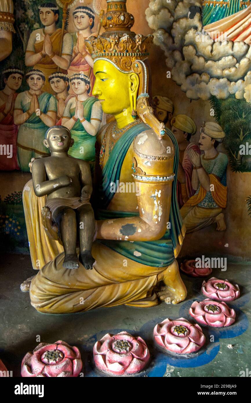 A statue of the baby Lord Buddha being cradled by his mother in a display located in the Image House at Wewurukannala Vihara at Dickwella, Sri Lanka. Stock Photo