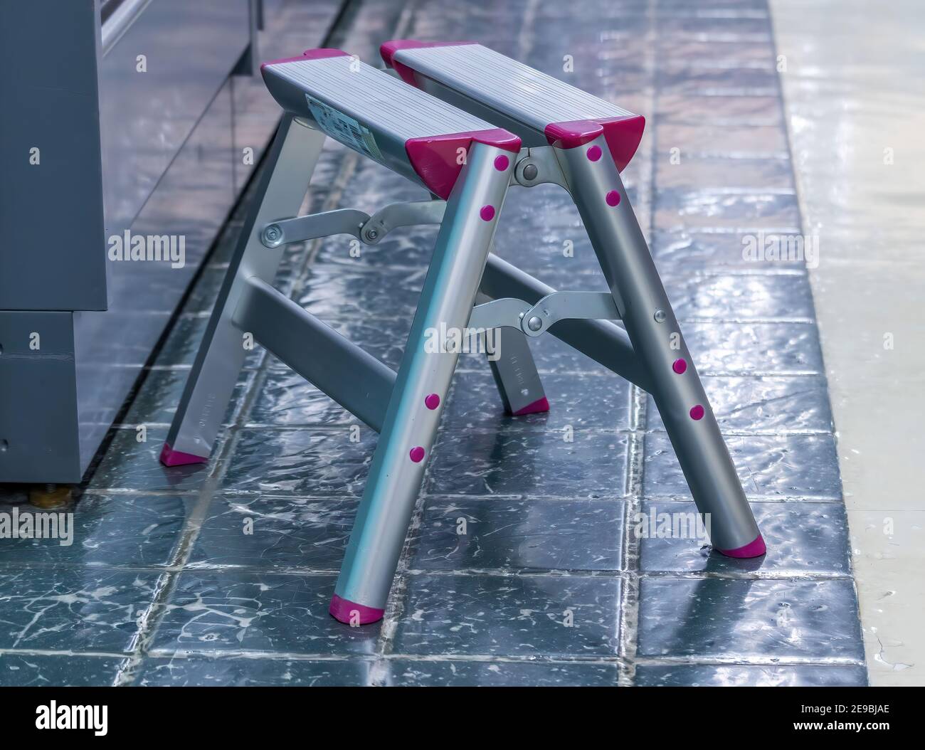 Small, aluminum step ladder, used in a shop to get to higher shelves