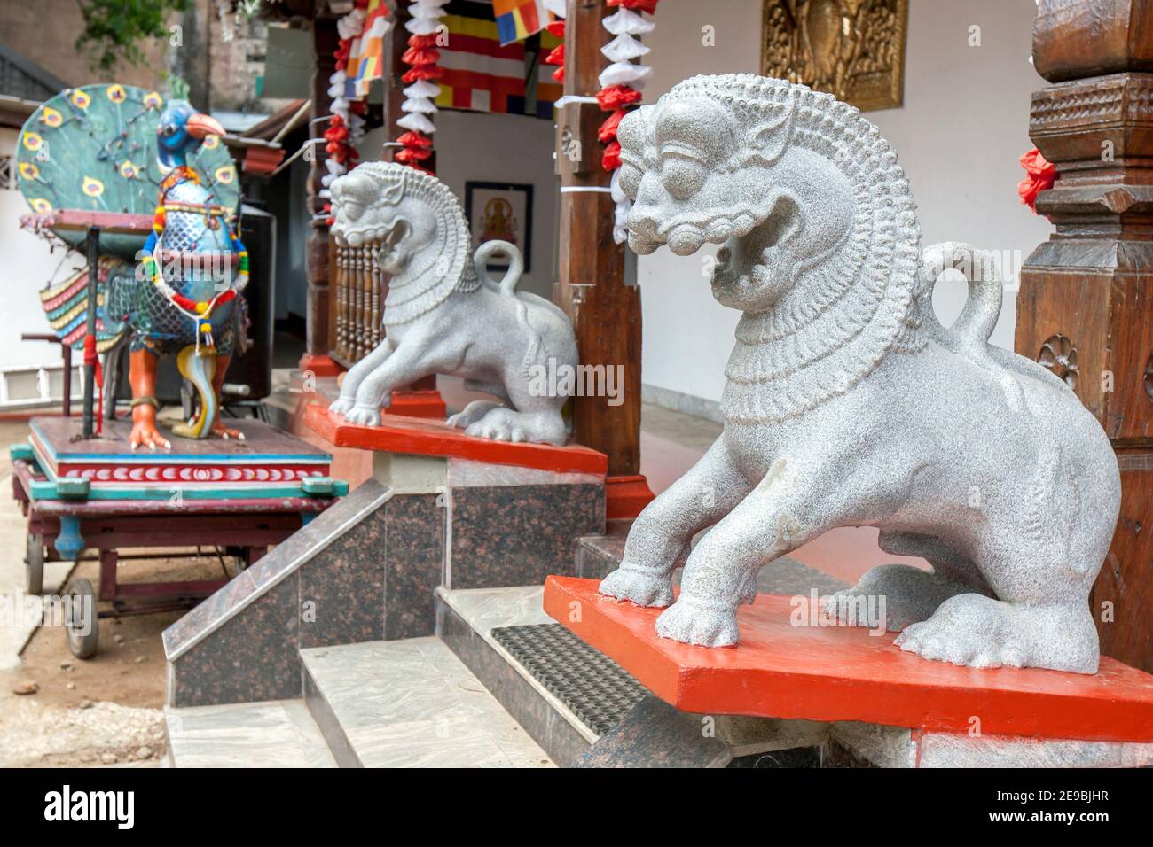 A pair of stone carved lion statues within the Kataragama Temple in