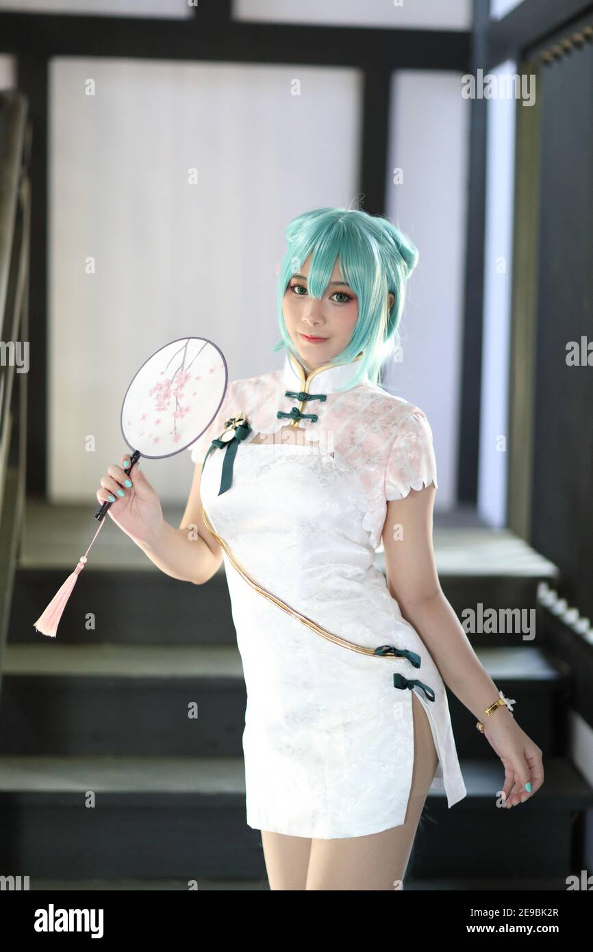 Japan anime cosplay portrait of a girl with chinese dress costume in chinese garden Stock Photo