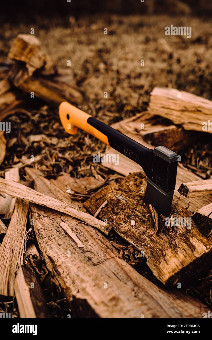 Hatchet stuck in log of fire wood Stock Photo