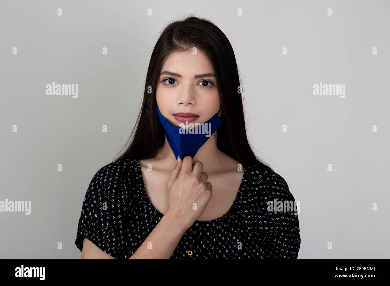 Image of a pretty young girl wearing Covid 19 protection mask and ...