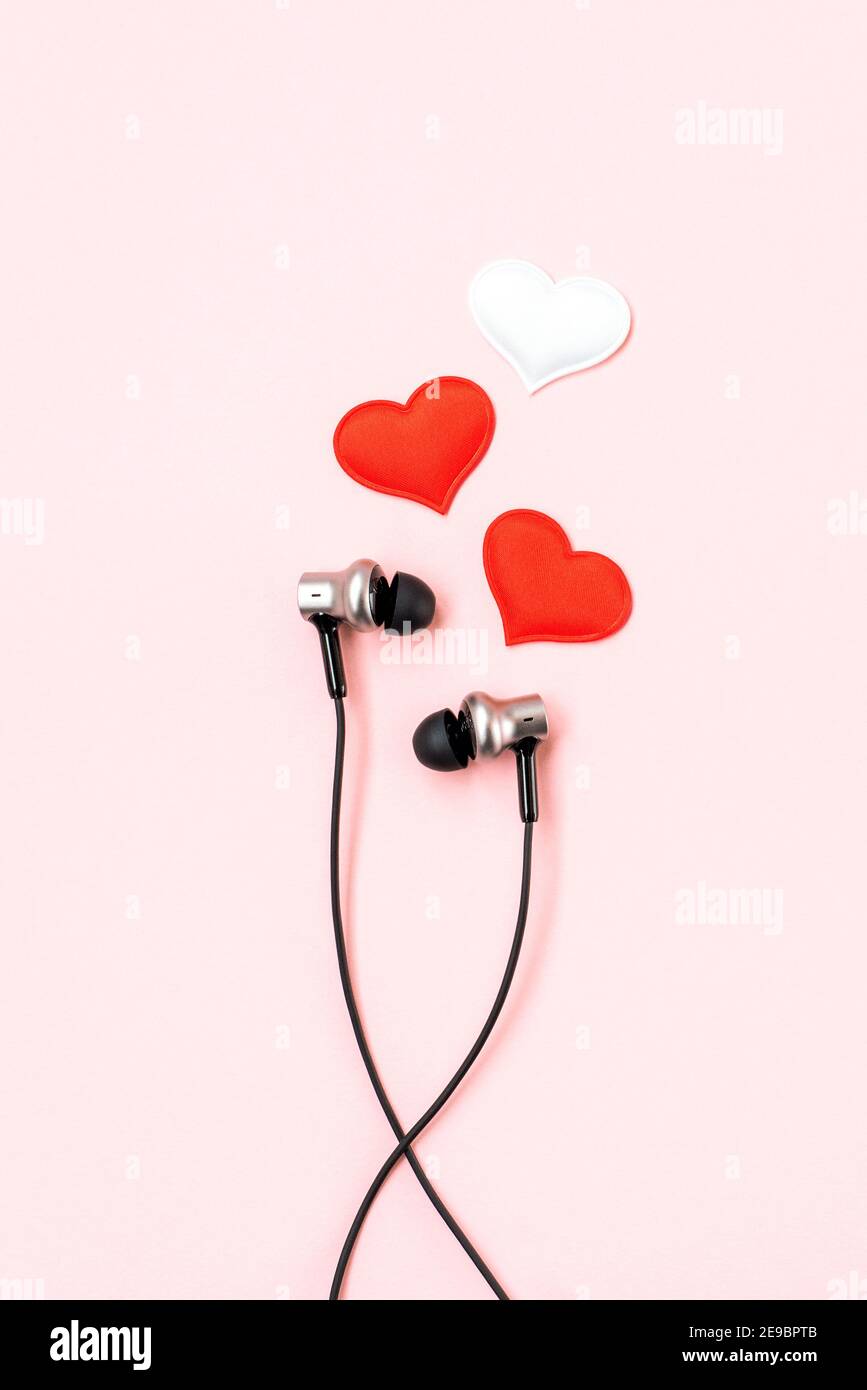 Red heart with music earphones on pink pastel background. Headphones like a  pair of lovers. Valentines Day backdrop. Minimalist postcard Stock Photo -  Alamy