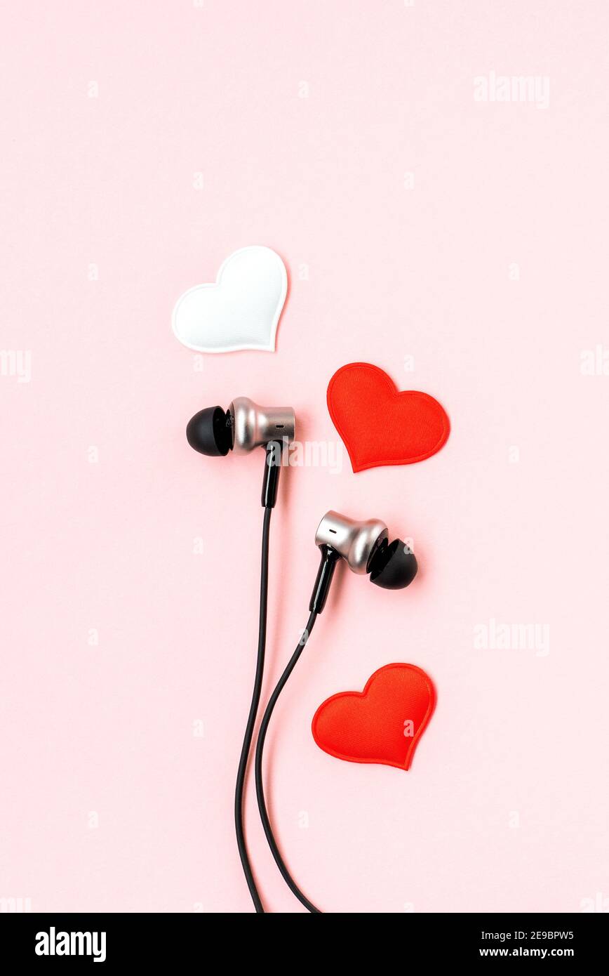 Red heart with music earphones on pink pastel background. Headphones like a  pair of lovers. Valentines Day backdrop. Minimalist postcard Stock Photo -  Alamy