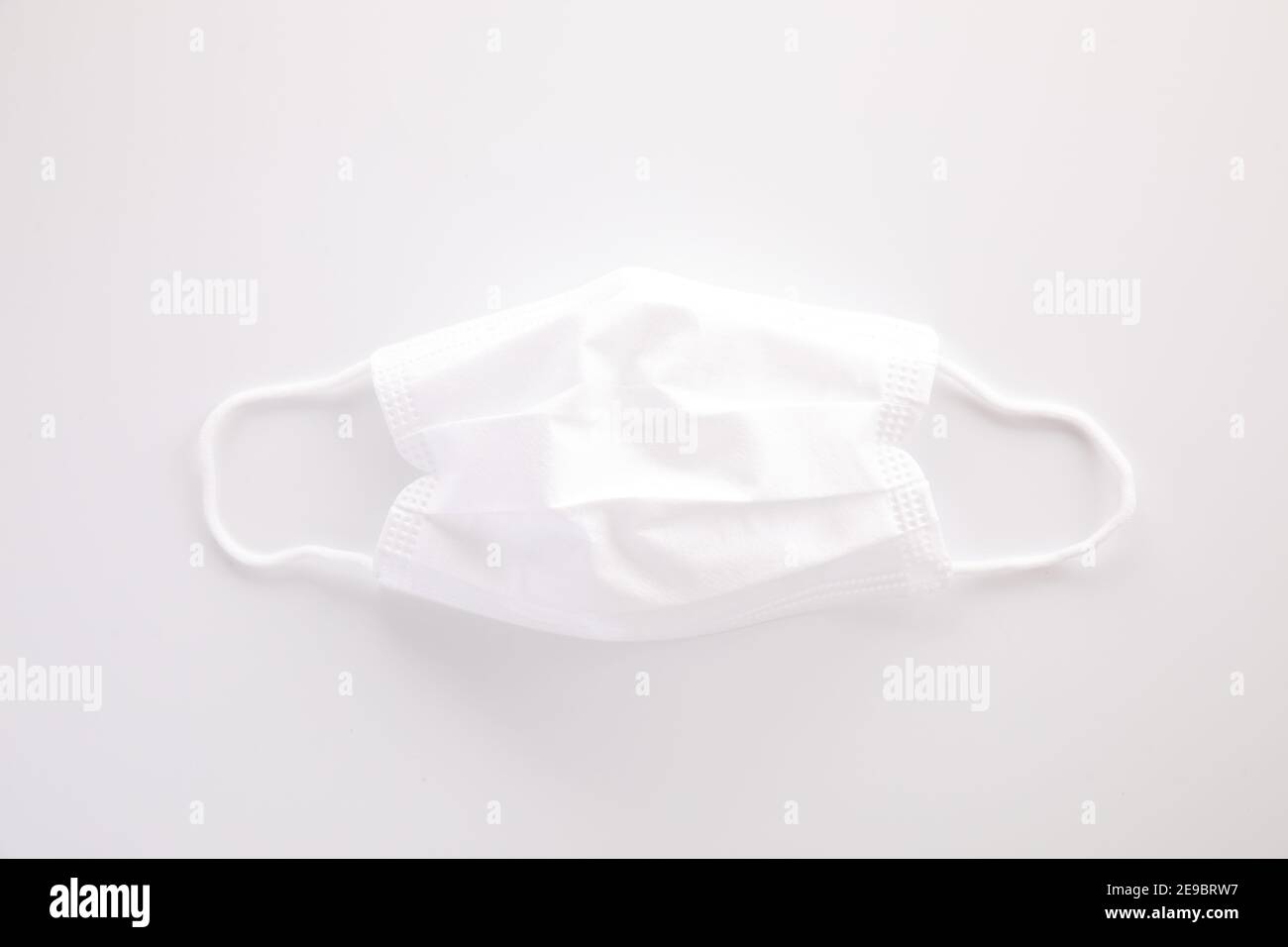 Used white mask isolated in white background Stock Photo - Alamy