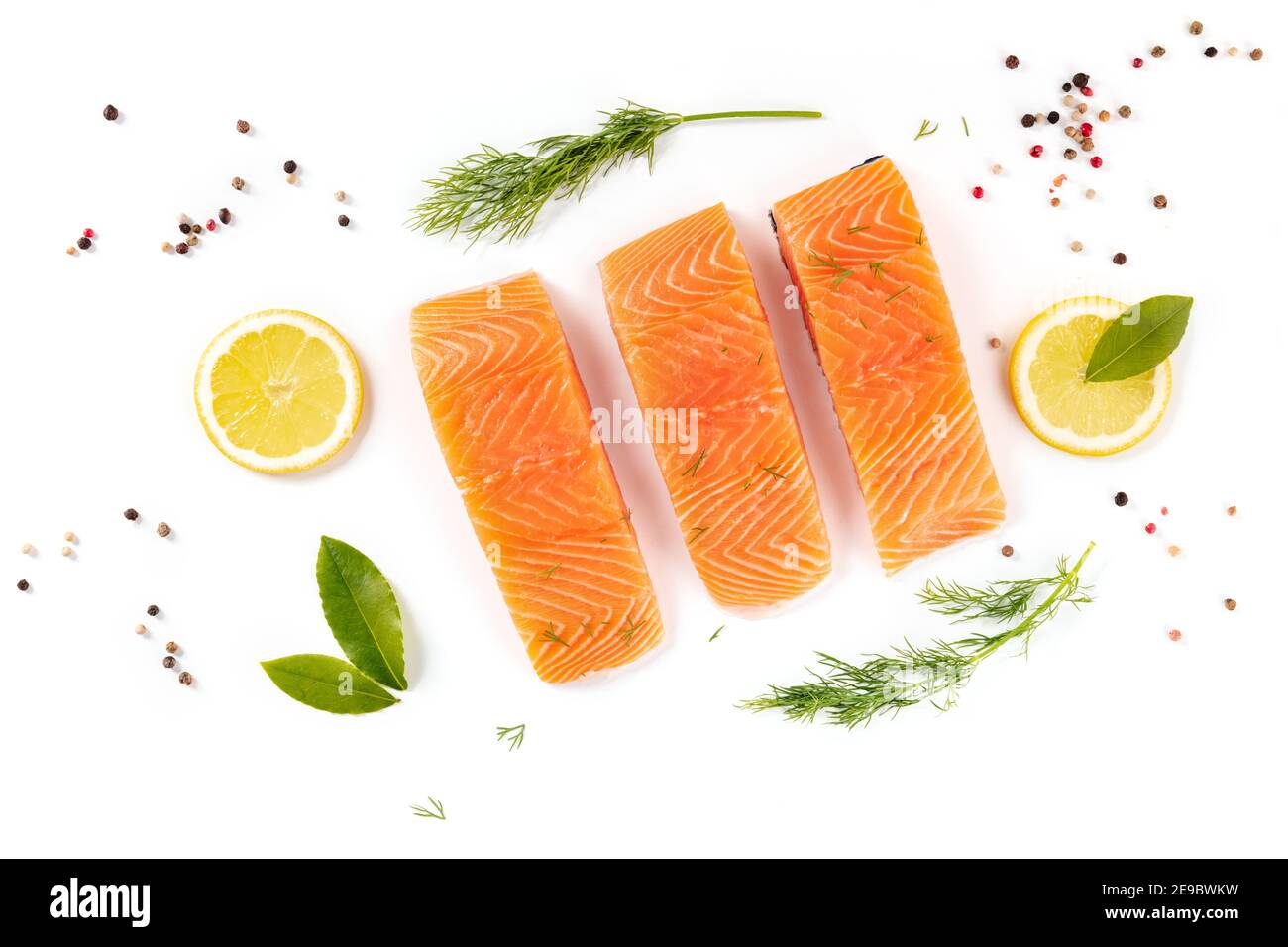 Raw salmon, shot from above with herbs and spices on a white background ...