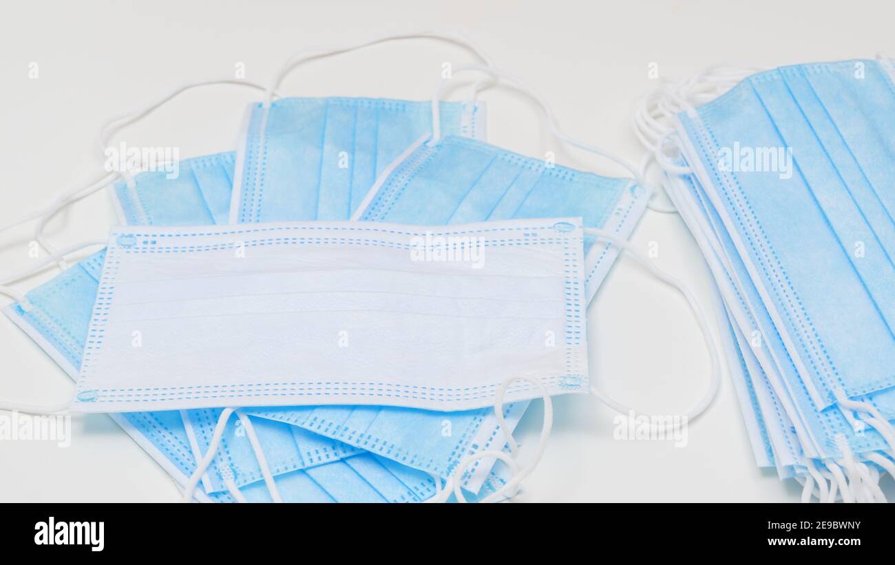 Protective disposable respiratory medical face masks close up on white ...